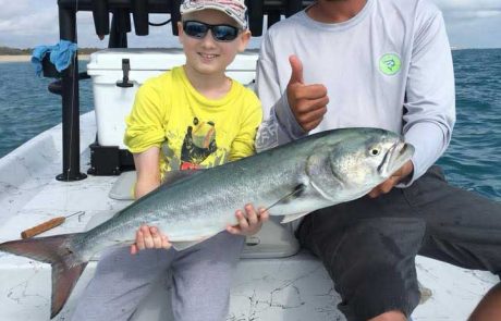 Capt Jesse and Evan with a big bluefish off the beach!